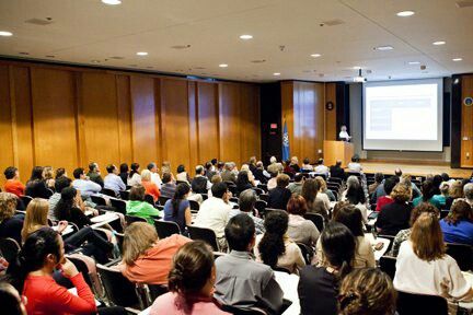 Audience attending a business seminar presentation in a conference hall