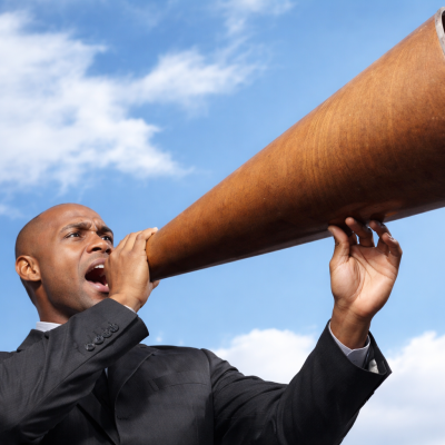 Man using a megaphone representing communication and guidance in financial services
